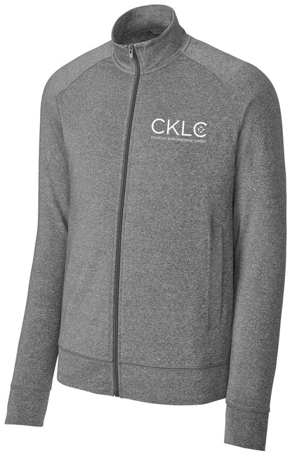 The Creative Kids Learning Center CKLC Sport-Tek Sport-Wick Stretch Full-Zip Cadet Jacket (ST857) features heather gray, long poly/spandex raglan sleeves, a stand-up collar, and a left chest white CKLC logo with “creative kids learning center” underneath.